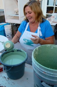 Pre-K teacher Linda Gartrell applies glaze to a mug she made.