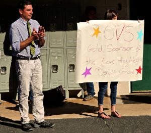 English teacher Brad Weidlich applauds news that OVS raised $500 for the Love Thy Neighbor benefit concert, and as a result is now a Gold Sponsor of the event -- Photo by Carrie Chen
