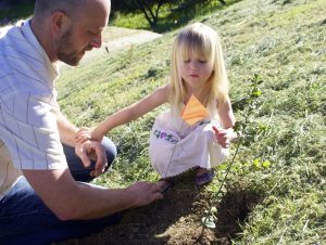 Director of Facilities and Grounds Mac Lojowski, with his daughter Isabella, take part in the planting -- Photo by Lauren Rothman