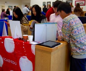 Students read literature at one of the 23 college booths -- Photo by Kendall Shiffman