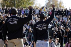 Members of the black student protest group, Concerned Student 1950, raise their arms while addressing a crowd following the announcement University of Missouri System President Tim Wolfe would resign Monday, Nov. 9, 2015, at the University of Missouri in Columbia, Mo. Wolfe resigned Monday with the football team and others on campus in open revolt over his handling of racial tensions at the school --  Photo by Jeff Roberson