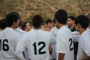 Soccer coach Hunter Helman gives his team a half-time pep talk during a recent game -- Photo by Minwoo Sohn
