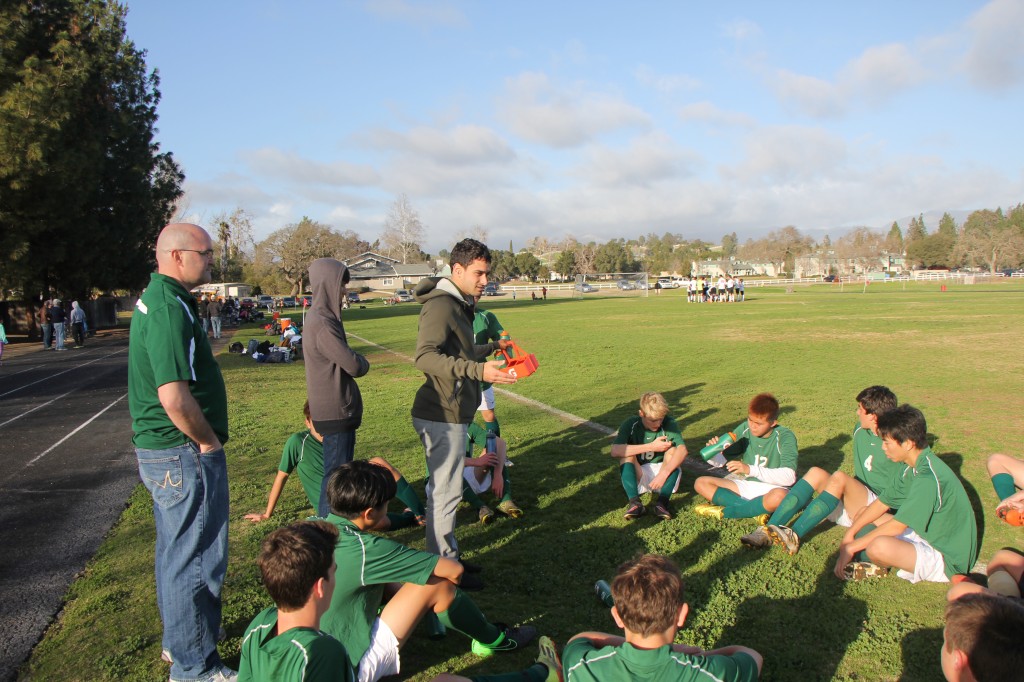 Soccer coach Hunter Helman talks to his players after a game -- Photo by Minwoo Sohn
