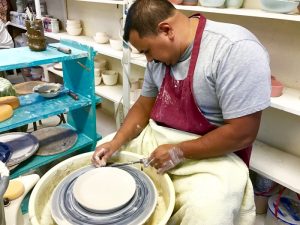 Upper Campus cook Moises Ferrel has become quite advanced in the craft of ceramics since taking lessons from Mrs. Cooper -- Photo by Fred Alvarez