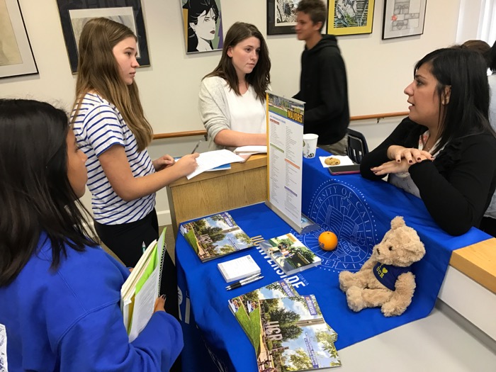 Juniors Clara Addison, Emma Gustafson and Leila GIannetti meet with the representative from UC Riverside at Wednesday's college fair -- Photo by Fred Alvarez