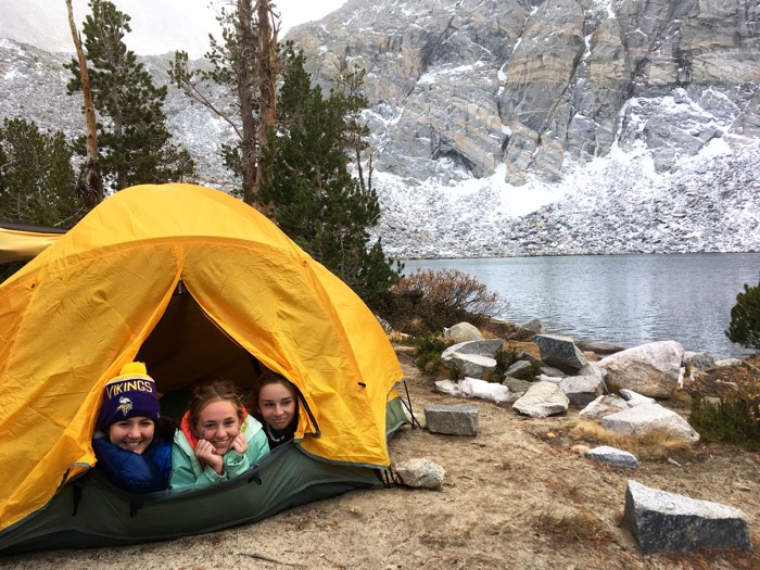OVS campers Maya Mullins, Lucy Orgolini and Caspian Ellis seek shelter from the snow in the eastern Sierra Nevada -- Photo by Zach Byars